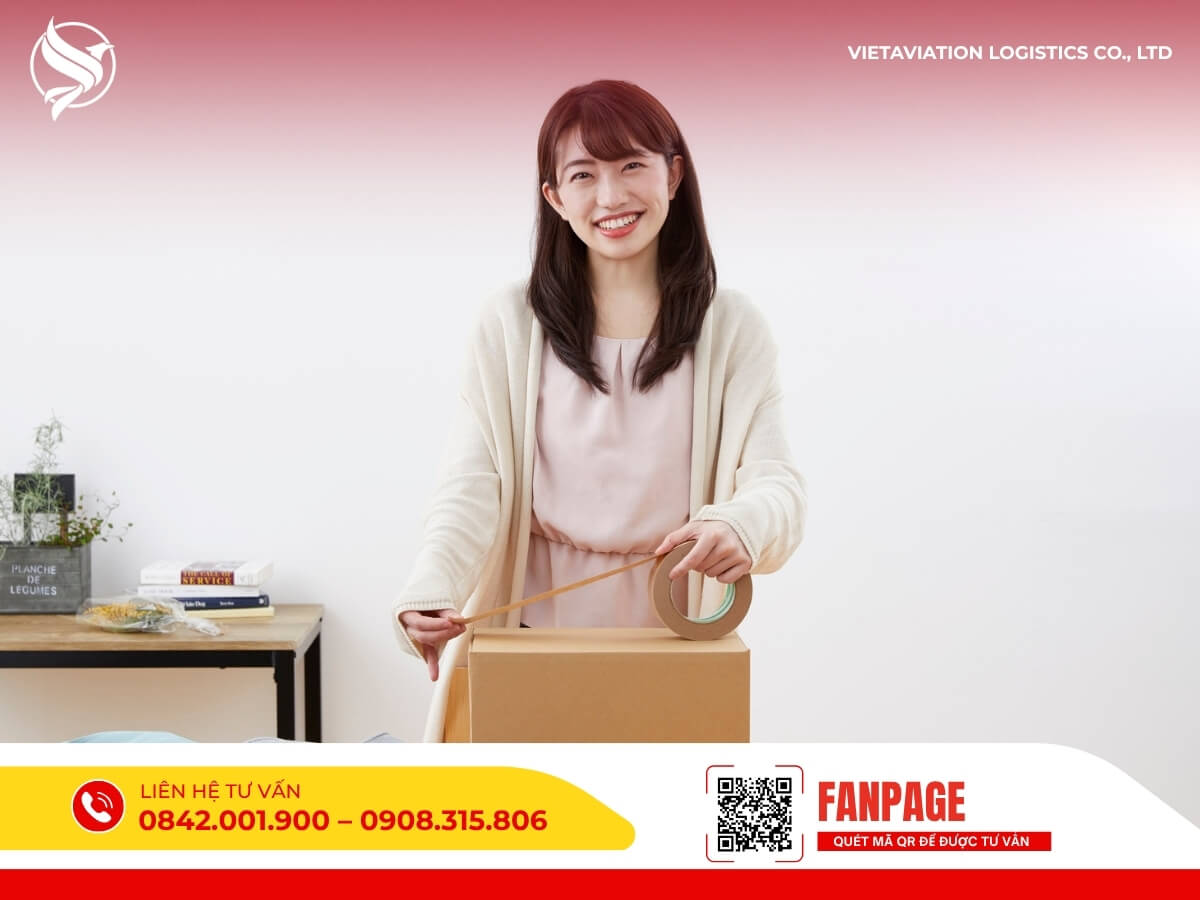 Cô gái trẻ đang cẩn thận dán băng keo đóng gói hàng hóa tại nhà trước khi gửi sang Trung Quốc.